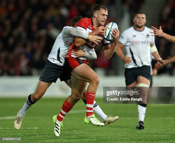 Max Llewellyn of Gloucester Rugby is tackled by Alex Goode of Saracens during the Gallagher Premiership Rugby match between Gloucester Rugby and...