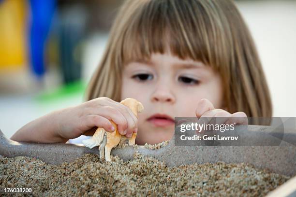 young girl playing with a toy dog - toy animal stock-fotos und bilder