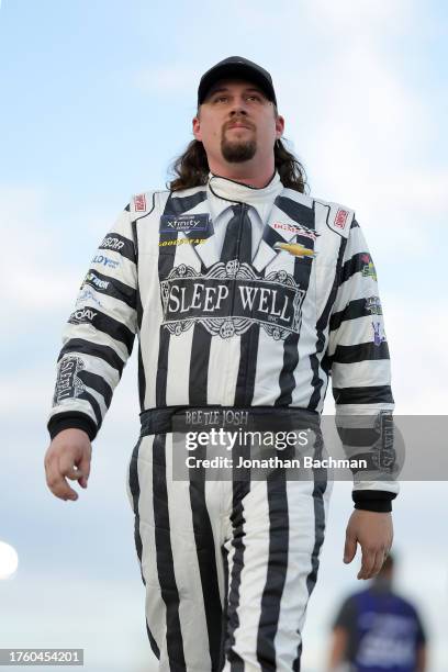 Josh Williams, driver of the Alloy Employer Services Chevrolet, walks the grid in a Beetlejuice themed fire suit during practice for the NASCAR...