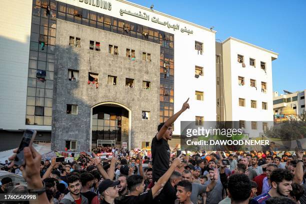 People congregating chant slogans and react outside Al-Shifa hopsital in Gaza City on November 2 amid the ongoing battles between Israel and the...