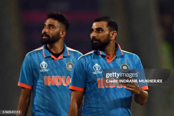 India's Mohammad Shami and Mohammed Siraj look at the screen for replay after the dismissal of Sri Lanka's Dushan Hemantha during the 2023 ICC Men's...