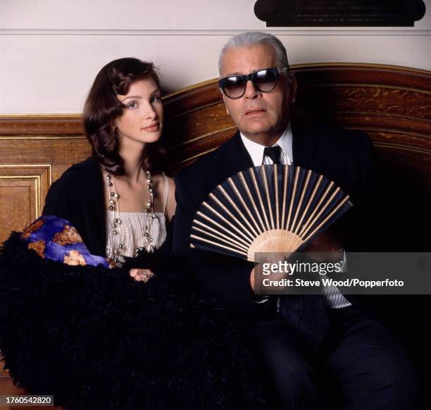 American supermodel Debbie Deitering with German fashion designer Karl Lagerfeld holding his signature fan, backstage at a Chanel fashion show, circa...