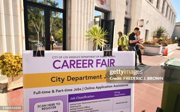 People enter and depart a career fair where job seekers can meet with prospective employers during a City of Los Angeles career fair offering to fill...