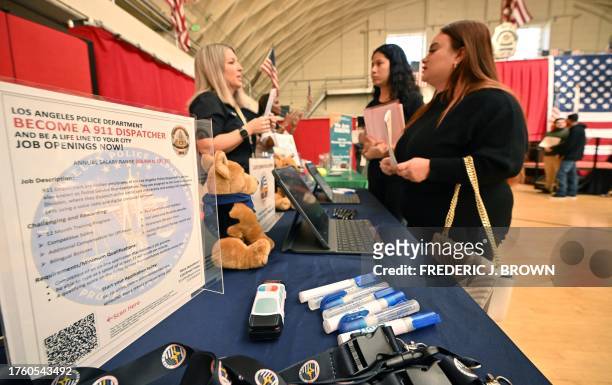 Job seekers speak with prospective employers during a City of Los Angeles career fair offering to fill vacancies in more than 30 classifications of...