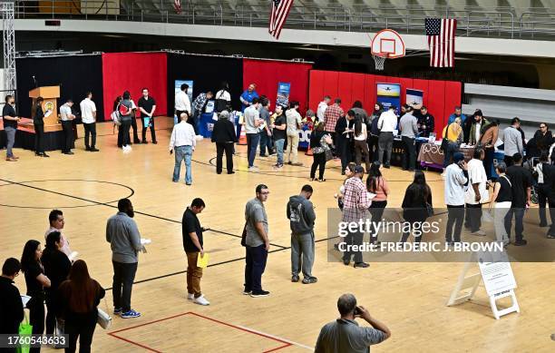 People wait in line for a chance to speak with prospective employers during a City of Los Angeles career fair offering to fill vacancies in more than...