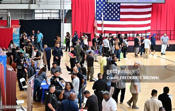 People wait in line for a chance to speak with prospective employers during a City of Los Angeles career fair offering to fill vacancies in more than...