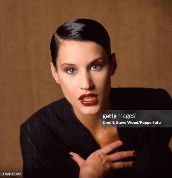 Canadian supermodel Eve Salvail wearing a black pinstripe suit during a fashion photoshoot, circa 1995.