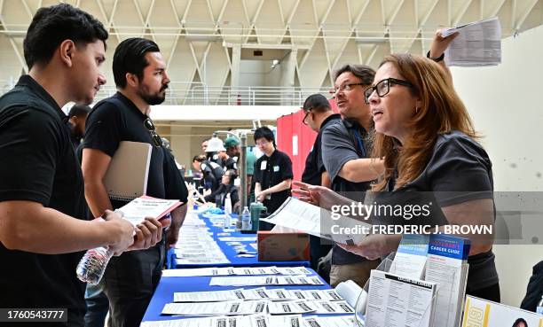 Job seekers speak with prospective employers during a City of Los Angeles career fair offering to fill vacancies in more than 30 classifications of...