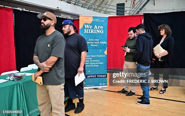 People wait in line for a chance to speak with prospective employers during a City of Los Angeles career fair offering to fill vacancies in more than...