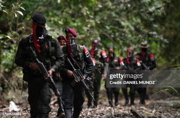 Rebels of the National Liberation Army patrol near the Baudo river iin Choco province, Colombia on October 26, 2023.