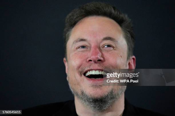 Tesla and SpaceX's CEO Elon Musk laughs during an in-conversation event with British Prime Minister Rishi Sunak at Lancaster House on November 2,...