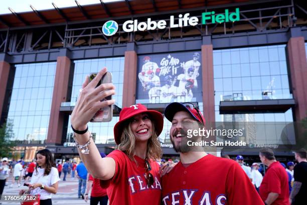 Fans take a selfie outside the stadium prior to Game One of the World Series between the Arizona Diamondbacks and the Texas Rangers at Globe Life...