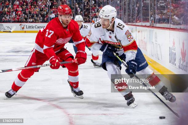 Matthew Tkachuk of the Florida Panthers controls the puck in front of J.T. Compher of the Detroit Red Wings during the second period at Little...