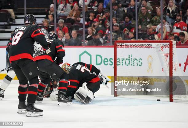 Anze Kopitar of the Los Angeles Kings scores a second period goal against Joonas Korpisalo of the Ottawa Senators as Travis Hamonic, Tim Stützle and...