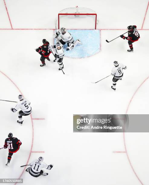 Dominik Kubalik of the Ottawa Senators scores a second period goal against Cam Talbot of the Los Angeles Kings as teammates Mathieu Joseph and...