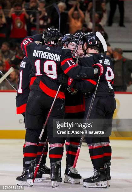 Josh Norris of the Ottawa Senators celebrates his third period goal against the Los Angeles Kings with teammates Drake Batherson, Jacob...