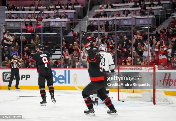 Josh Norris of the Ottawa Senators celebrates his third period goal against the Los Angeles Kings with teammate Vladimir Tarasenko as Matt Roy of the...