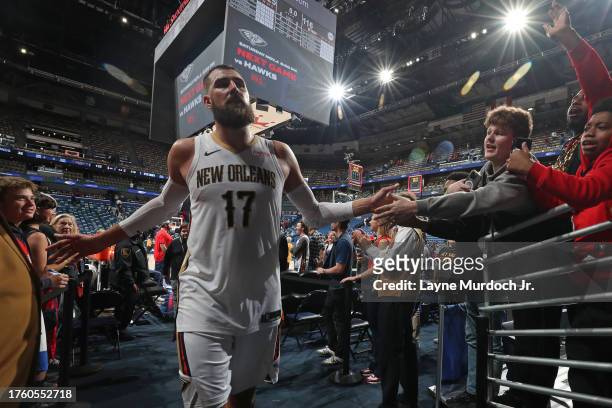 Jonas Valanciunas of the New Orleans Pelicans high fives fans after the game against the Detroit Pistons on November 2, 2023 at the Smoothie King...