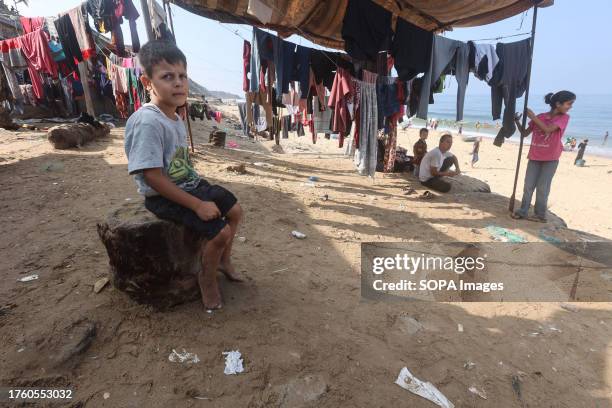 Palestinians gather on the beach to do their laundry along the beach in Deir el-Balah in the southern Gaza Strip. In an escalating air and ground...