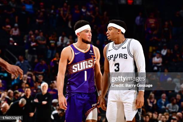 Devin Booker of the Phoenix Suns speaks to Keldon Johnson of the San Antonio Spurs during the game on November 2, 2023 at Footprint Center in...