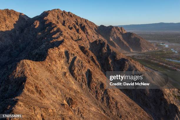 In an aerial view, the PGA West golf resort abuts the native habitat of endangered desert bighorn sheep and lacks completed fencing to keep bighorns...