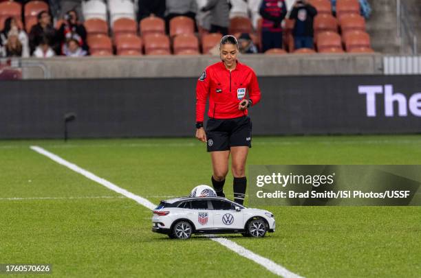Referee Melissa Borjas takes the ball from a Volkswagen remote controlled car during a game between Colombia and USWNT at America First Field on...
