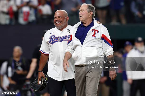 Former member of the Texas Rangers Ivan Rodriguez and former US President George W. Bush meet during a ceremonial first pitch prior to Game One of...