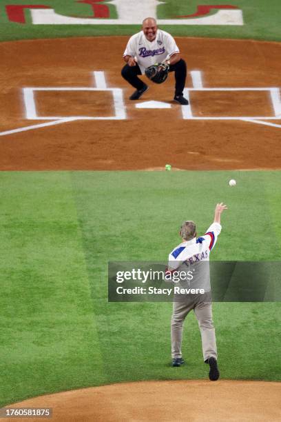 Former US President George W. Bush throws a ceremonial first pitch to former member of the Texas Rangers Ivan Rodriguez prior to Game One of the...
