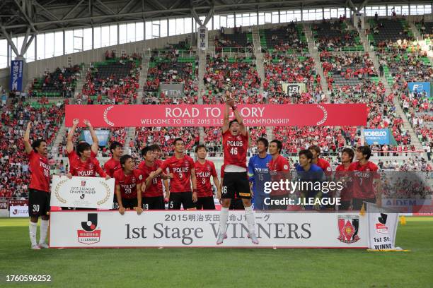 Ryota Moriwak of Urawa Red Diamonds lifts the trophy at the award ceremony as the team celebrates the J.League J1 first stage champions following the...