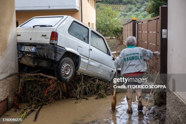 Woman tries to clean the mud in Montemurlo near Prato after heavy rain last night, on November 3, 2023. Storm Ciaran hit Tuscany late on November 2,...