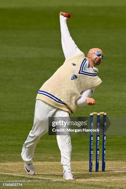 Nathan Lyon of New South Wales bowls during the Sheffield Shield match between Victoria and New South Wales at Melbourne Cricket Ground, on October...