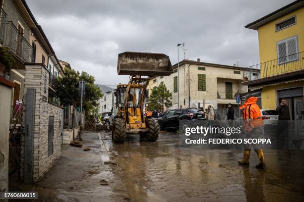 Bulldozers are used to remove debrees from the streets in Montemurlo, near Prato, after heavy rain last night, on November 3, 2023. Storm Ciaran hit...
