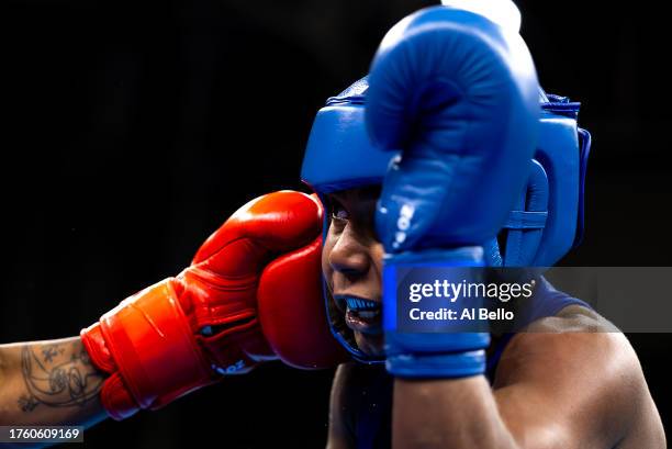 Jucielen Cerqueira Romeu of Team Brazil receives a punch from Valeria Arboleda of Team Colombia Women’s 57kg boxing gold medal bout at Centro de...