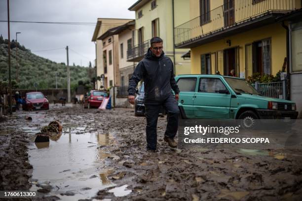 Man walks in the mud in Montemurlo, near Prato, after heavy rain last night, on November 3, 2023. Storm Ciaran hit Tuscany late on November 2, 2023...