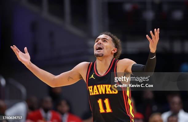 Trae Young of the Atlanta Hawks reacts after hitting a three-point basket against the New York Knicks during the first quarter at State Farm Arena on...