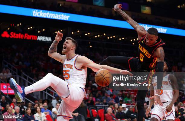 Isaiah Hartenstein of the New York Knicks reacts after dunking against Dejounte Murray of the Atlanta Hawks during the first quarter at State Farm...