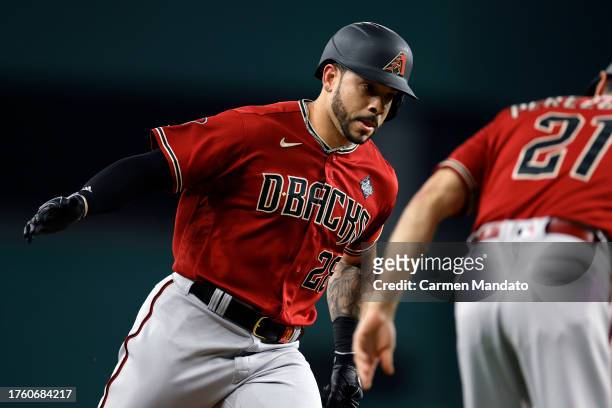 Tommy Pham and third base coach Tony Perezchica of the Arizona Diamondbacks celebrate after Pham hit a home run in the fourth inning against the...