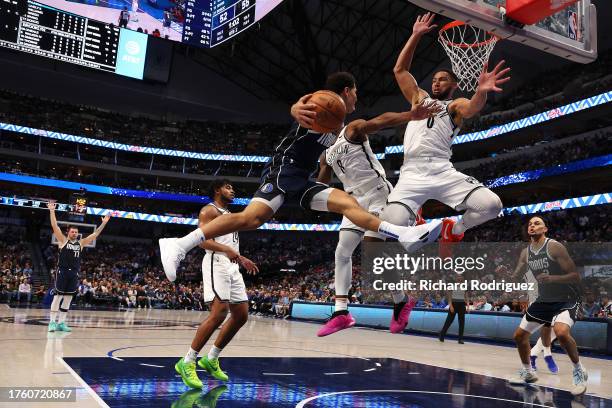 Josh Green of the Dallas Mavericks goes to pass the ball against Ben Simmons of the Brooklyn Nets in the second quarter at American Airlines Center...