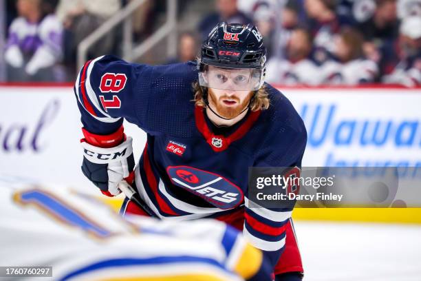 Kyle Connor of the Winnipeg Jets looks on as he gets set during a third period face-off against the St. Louis Blues at the Canada Life Centre on...