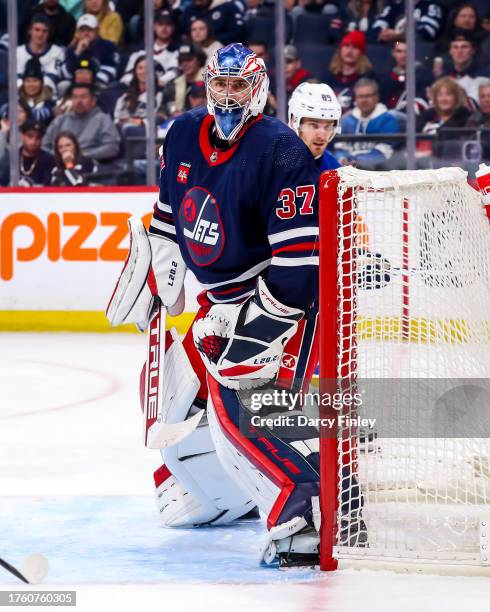 Goaltender Connor Hellebuyck of the Winnipeg Jets guards the net during third period action against the St. Louis Blues at the Canada Life Centre on...