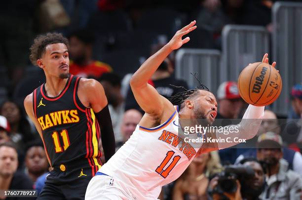 Jalen Brunson of the New York Knicks draws a foul from Trae Young of the Atlanta Hawks during the fourth quarter at State Farm Arena on October 27,...