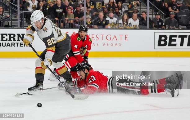 Philipp Kurashev and Seth Jones of the Chicago Blackhawks break up a pass to Chandler Stephenson of the Vegas Golden Knights in overtime of their...