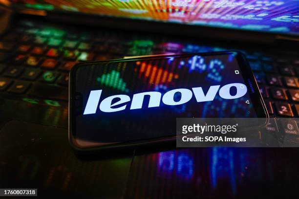 In this photo illustration, the Lenovo logo is displayed on a smartphone.