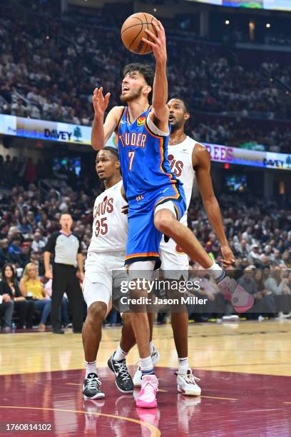 Chet Holmgren of the Oklahoma City Thunder shoots over Isaac Okoro and Evan Mobley of the Cleveland Cavaliers at Rocket Mortgage Fieldhouse on...