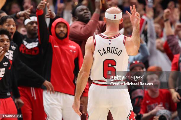 Alex Caruso of the Chicago Bulls celebrates a three pointer with 2.3 seconds remaining in overtime against the Toronto Raptors at the United Center...
