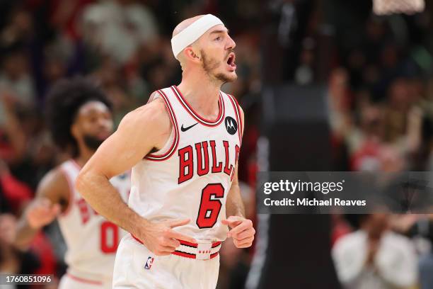Alex Caruso of the Chicago Bulls celebrates a three pointer with 2.3 seconds remaining in overtime against the Toronto Raptors at the United Center...