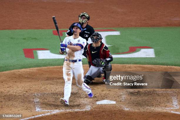 Corey Seager of the Texas Rangers hits a home run in the ninth inning against the Arizona Diamondbacks during Game One of the World Series at Globe...
