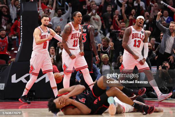 DeMar DeRozan of the Chicago Bulls celebrates with Zach LaVine and Torrey Craig of the Chicago Bulls after making a basket during the second half...