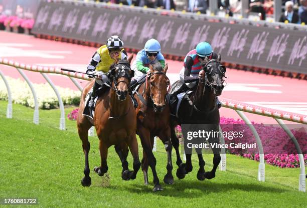 Mark Zahra riding Prowess defeats Blake Shinn riding Antino and Jamie Kah riding Tuvalu in Race 5, the Mccafe Crystal Mile, during Melbourne Racing...