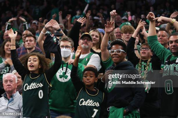 Boston Celtics fans wave for free t-shirts during the game between the Boston Celtics and the Miami Heat at TD Garden on October 27, 2023 in Boston,...
